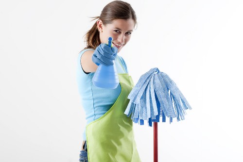 Cleaner preparing oven cleaning equipment safely before work